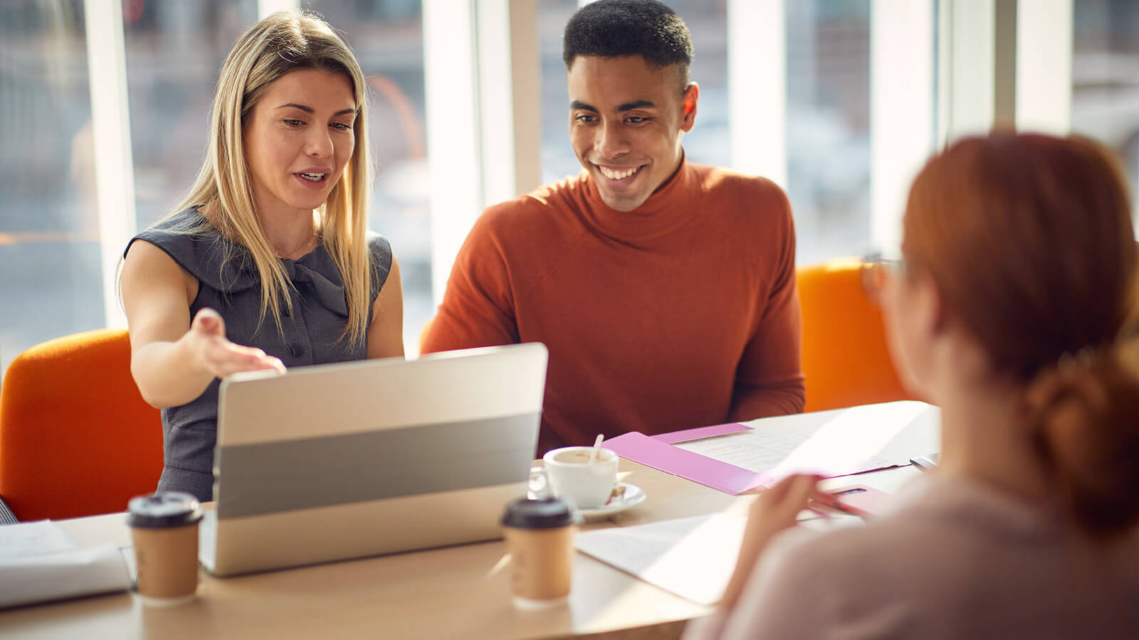 woman and intern working together at computer