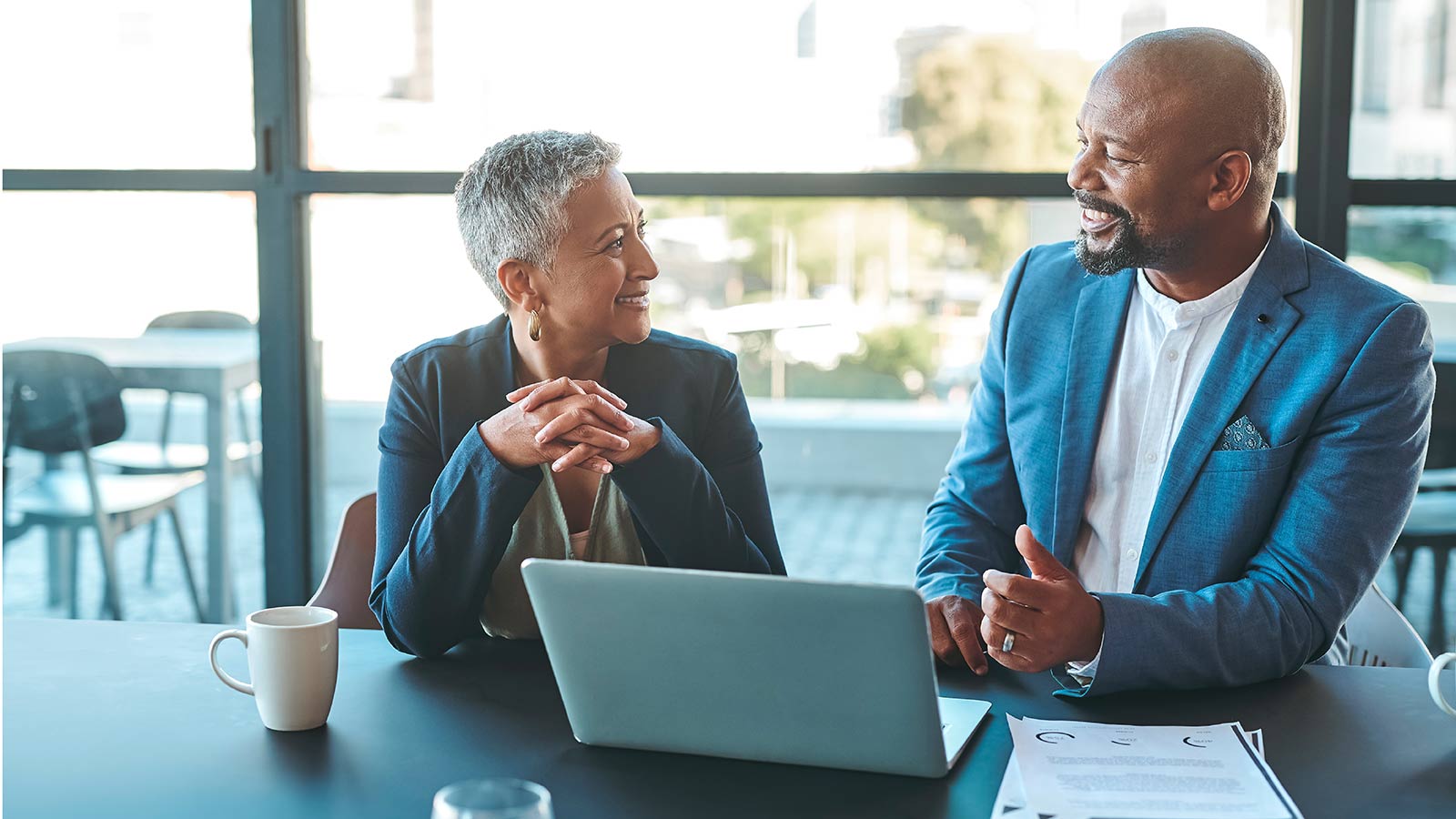 A woman planning for her retirement years meets with her financial professional to discuss converting an IRA to a Roth IRA.