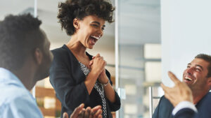Happy lady standing among friends.