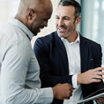 Two men having a discussion in an office.