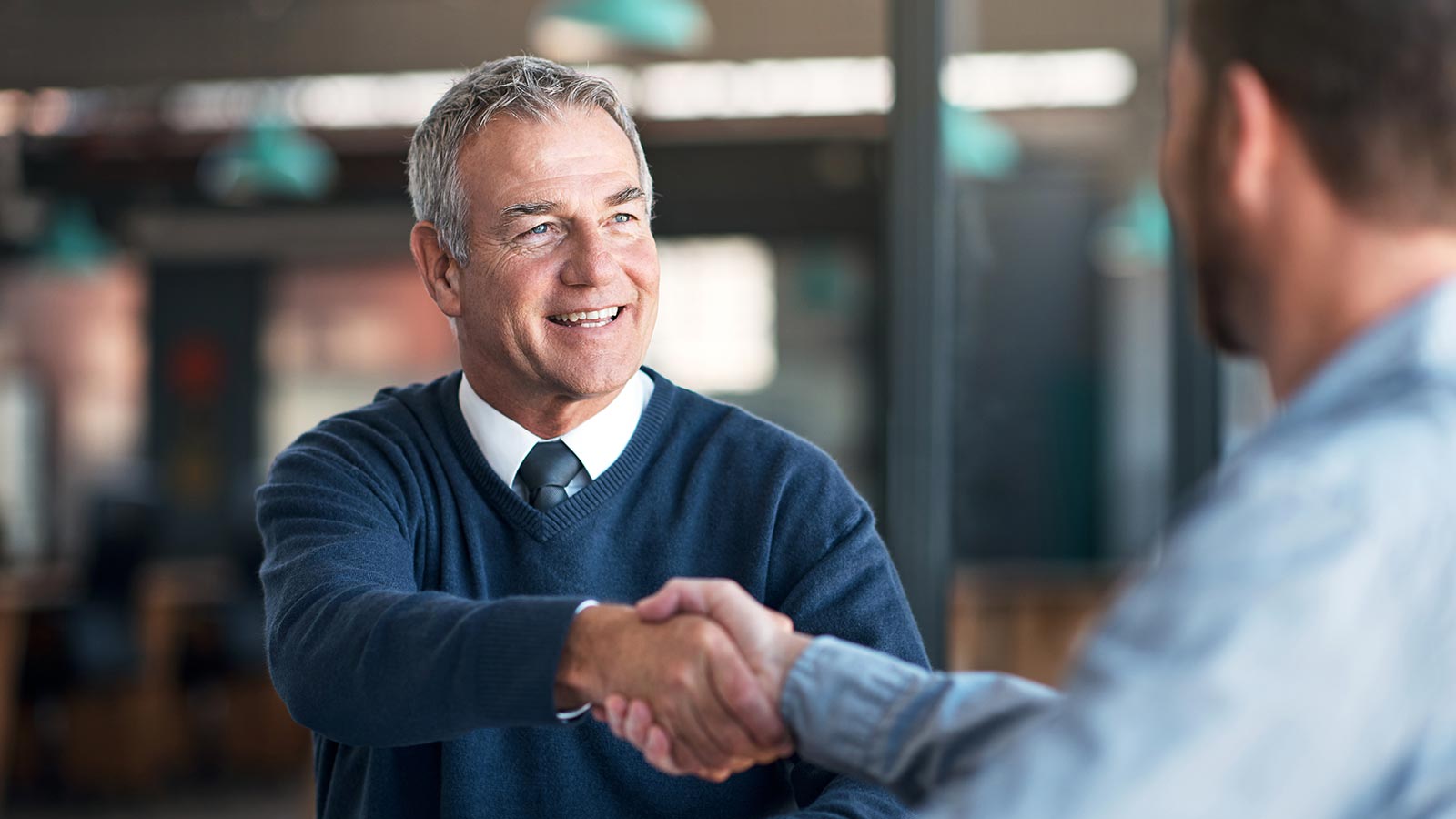 Two men shaking hands in agreement.