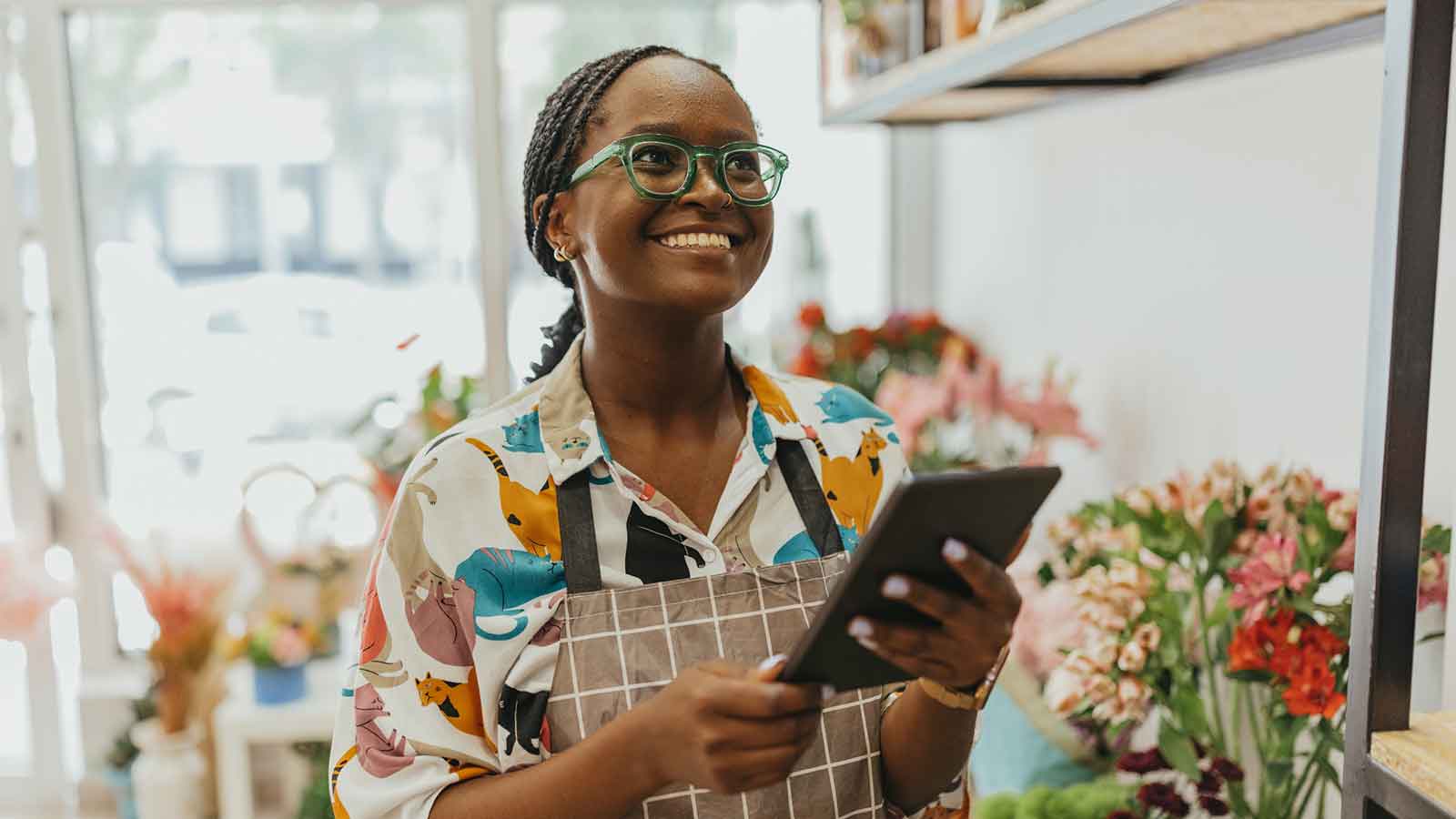 A small business owner runs her flower shop.