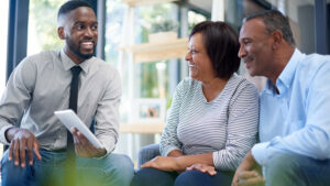 A husband and wife in their 50s meet with their financial professional to discuss using annuities and life insurance for retirement planning.