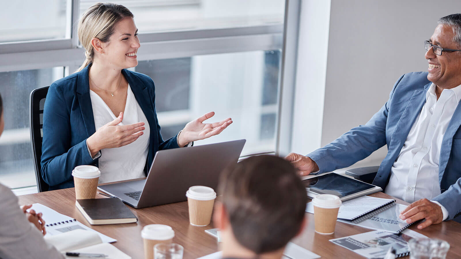 A financial professional meets with a leader at the financial services company she works with to discuss ideas for growth and improvement.